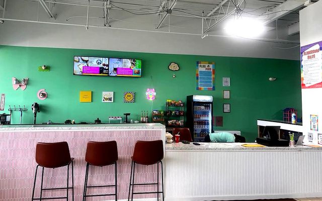 518 Play Academy Parent Cafe with colorful seating area, menu displays, and refreshment station