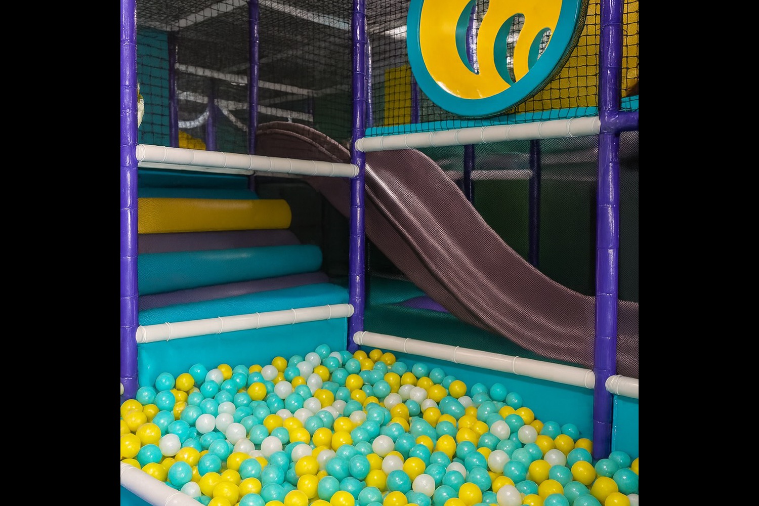 Mint and yellow balls in the play area's ball pit